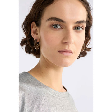 Pair of silver hoop earrings on a light gray background.