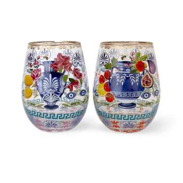 Two decorative glass tumblers with floral and fruit design on a white background.