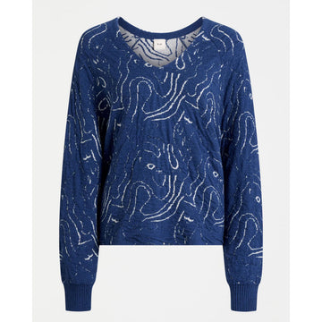 Blue sweater with white abstract patterns on a white background.