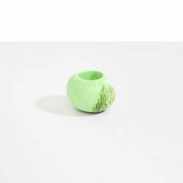 A small irregular shaped round vase in green resin.