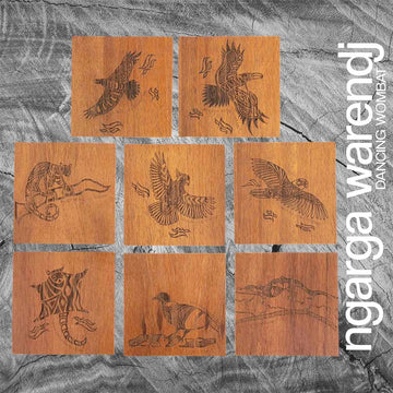 A set of eight square wooden coasters each etched with a different animal or bird.