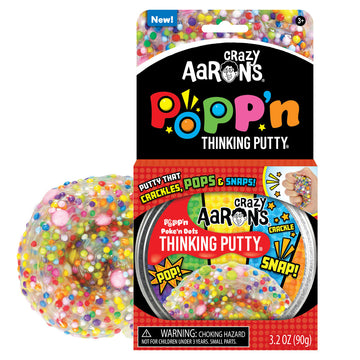 An open card packet with the heading 'Crazy Aarons Popp'n Thinking Putty' with a round container of putty in the packet. There is some putty filled with coloured dots next to the box.