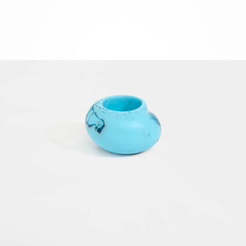 A small irregular shaped round vase in blue resin.