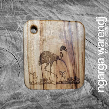 Wooden cutting board with emu engraving on a textured gray background, featuring the brand 'ngarga warendj'.