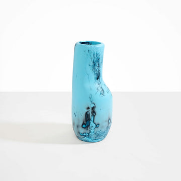 An irregular shaped resin vase in blue.