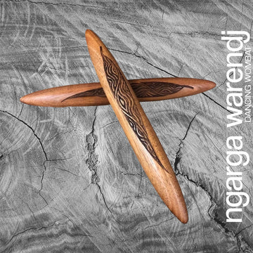 A pair of wooden clapsticks engraved with a design.