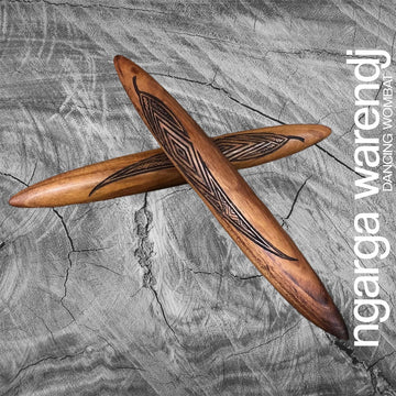 A pair of wooden clapsticks engraved with a design.