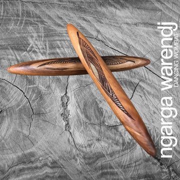 A pair of wooden clapsticks engraved with a design.