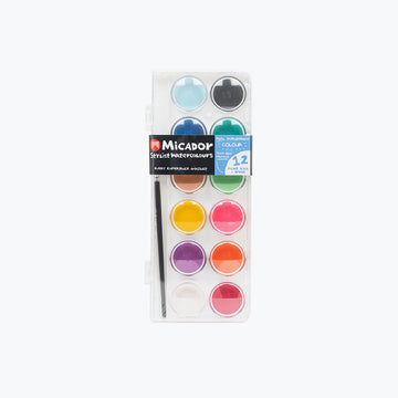 Set of watercolor paints with a brush in a clear plastic case on a white background.