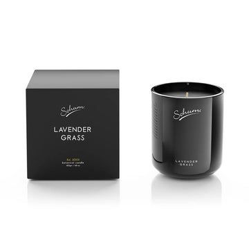 A black candle next to a matching black box with the text 'Sohum Lavender Grass' written on both items.