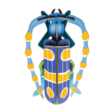 Colorful beetle-shaped object made from coloured cardboard on a white background.