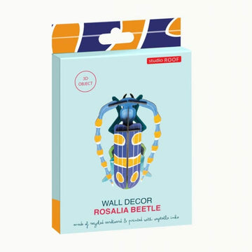 Colorful beetle-shaped object made from coloured cardboard on a white background.