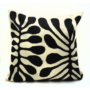 A square cushion made from wool and printed with artwork by Mitjili Napurrula in black and white.