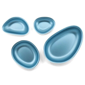 Set of four blue differently sized bowls on a white background.