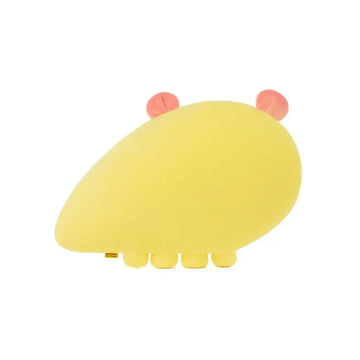Yellow cartoon character plushie with pink accents on a white background.