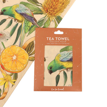 A tea towel printed with birds, flowers and fruits.