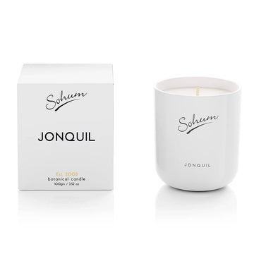 A white candle next to a matching white box with the text 'Sohum Jonquil' written on both items.