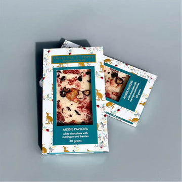 Two boxes of Sweet Pea & Poppy chocolate titled 'Aussie Pavlova' with Australian Christmas packaging.
