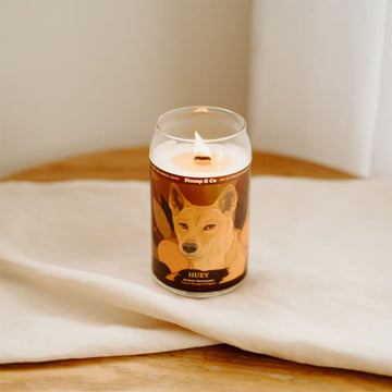 A can shaped candle illustrated with a dingo on the front.