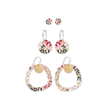 Three pairs of circular shaped earrings in studs, hoops and drops printed with light pink florals.