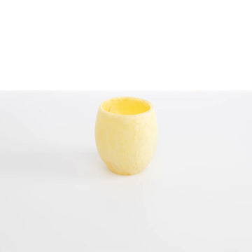 A yellow lemon coloured resin tumbler.