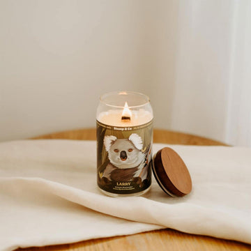 A can shaped candle with an illustration of a koala on the front.