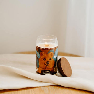 A can shaped candle illustrated with a quokka on the front.