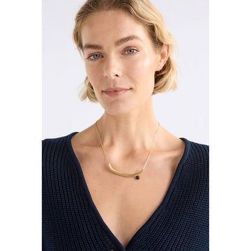 Necklace with a green bead on a white background.