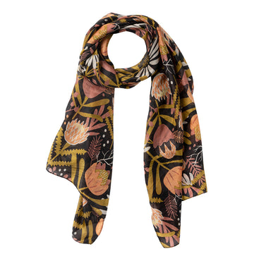 A silk scarf printed with protea flowers in orange and black.