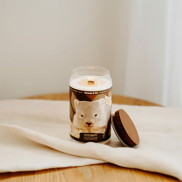 A can shaped candle illustrated with a wombat on the front.