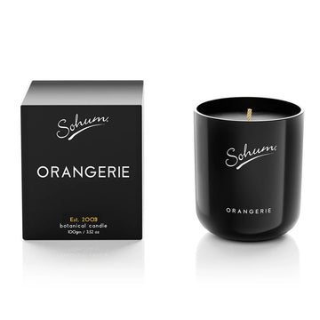 A black candle next to a matching black box with the text 'Sohum Orangerie' written on both items.