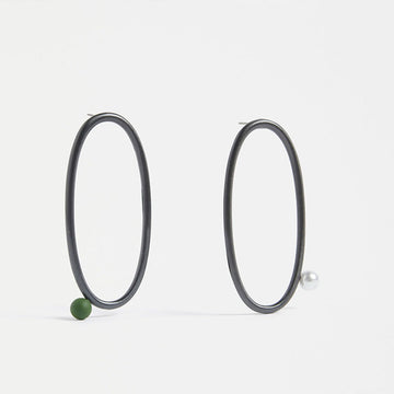 A pair of large Gunmetal hoops with a one bead placement.