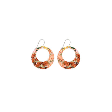 A pair of circle outline earrings printed with orange florals attached to a drop.