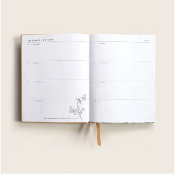 2026 planner with floral design on a beige background.