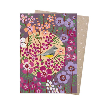 Greeting card with a colorful floral design and a bird on a purple background, with a matching envelope.