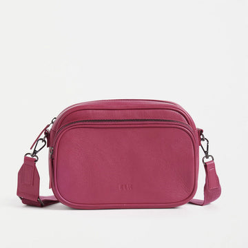 Front view of a cross body bag in fuchsia leather.