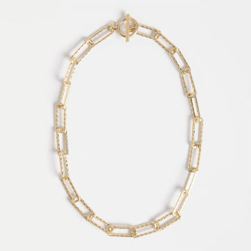 Gold chunky chain necklace on a light grey background.