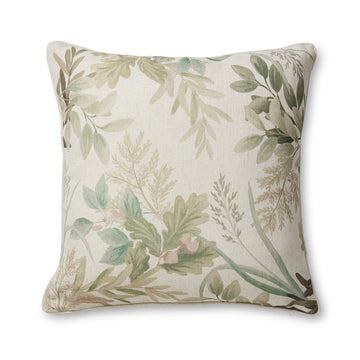A square cushion in a cream colour printed with different leaves.