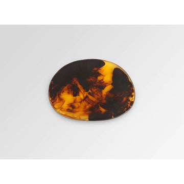 Top down view of a resin plate with a tortoiseshell swirl pattern.