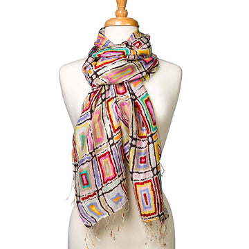 A silk scarf printed with artwork by Lynette Singleton is wrapped around the neck of a mannequin.