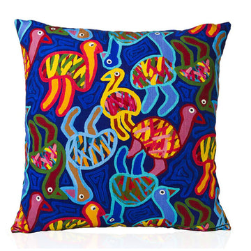 A dark blue cushion cover illustrated with colourful emus by Thelma Beeton.