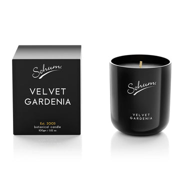A black candle next to a matching black box with the text 'Sohum Velvet Gardenia' written on both items.