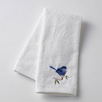 A white hand towel embroidered with a blue wren.