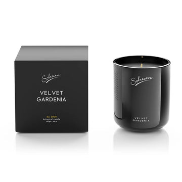 A black candle next to a matching black box with the text 'Sohum Velvet Gardenia' written on both items.