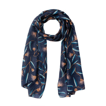 A silk scarf printed with flowering gums in orange on a dark blue background.