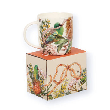 A ceramic mug illustrated with a bird and flowers.