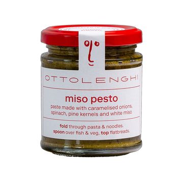 A jar filled with pesto sauce and a white label on the front with the text 'Miso Pesto'.