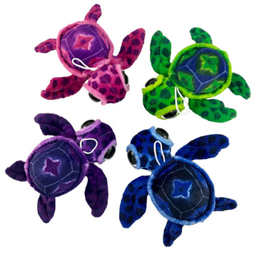 Top down view of four different coloured turtle soft toys.