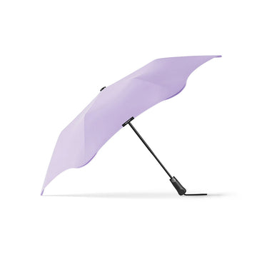 An open umbrella in lilac with a black handle.
