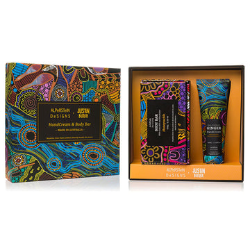 An open box showing the cover printed with artwork by Justin Butler and the inside showing a box and a tube with soap and hand cream inside. Both items are also printed with artwork by Justin Butler.